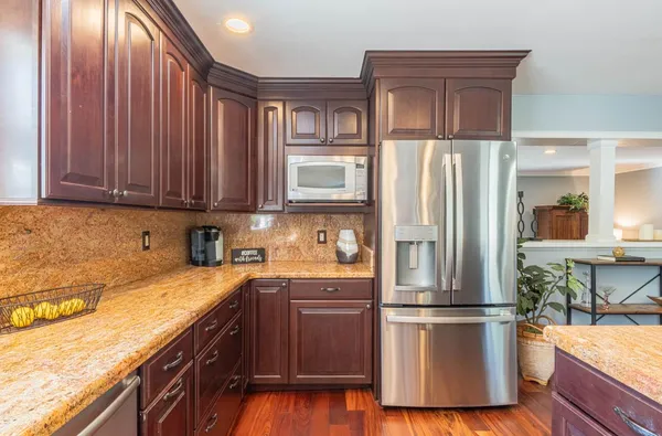 a kitchen with stainless steel appliances granite countertop a refrigerator sink and cabinets