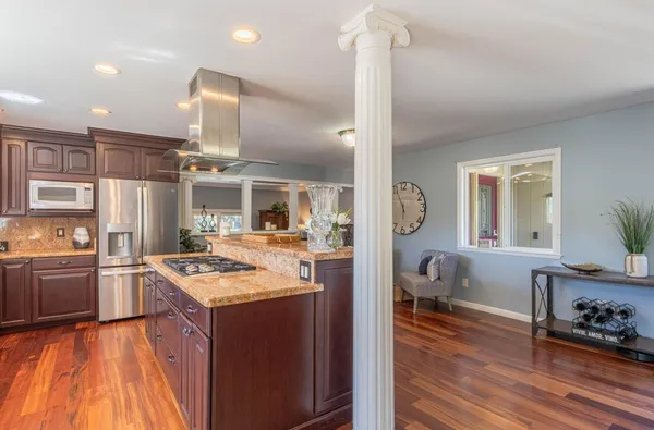 a kitchen with a stove a refrigerator and a fireplace