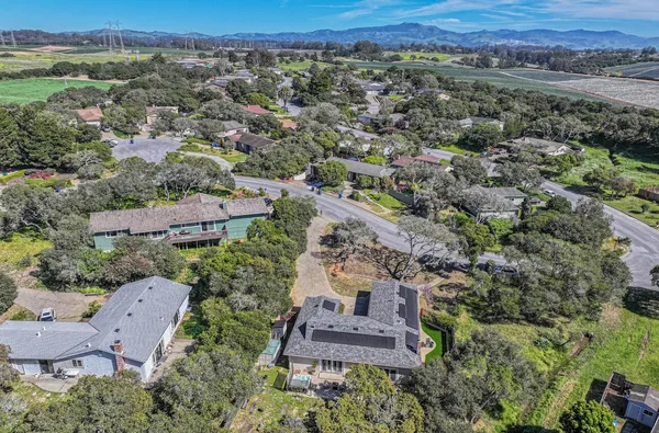 an aerial view of a house with a yard