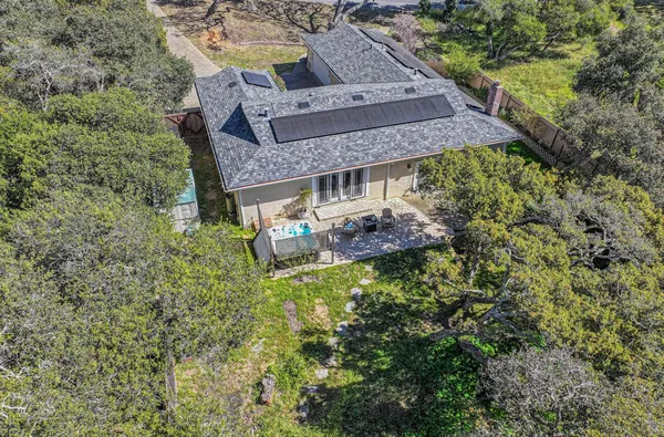 an aerial view of a house with a yard
