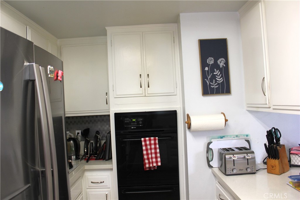 5911 Green Valley Road Riverside, CA 92504 - Photo 6 of 24 a kitchen with granite countertop a refrigerator and a sink