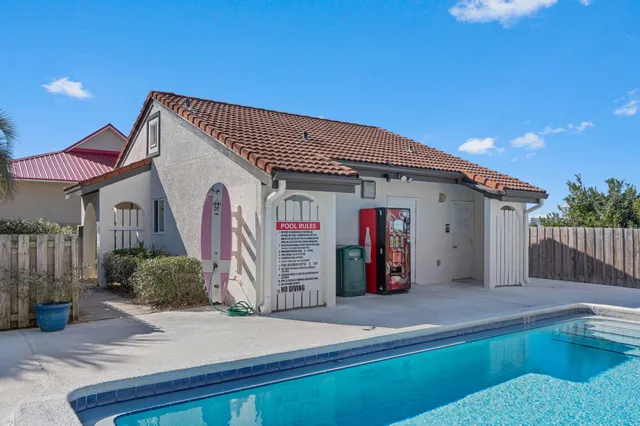 a view of a building with backyard and sitting area