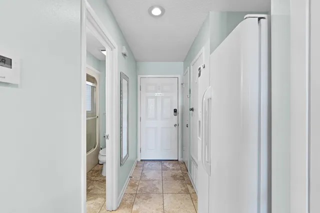 a room with a white cabinets and white appliances