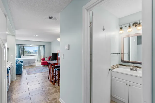 a view of a dining room with furniture and a chandelier