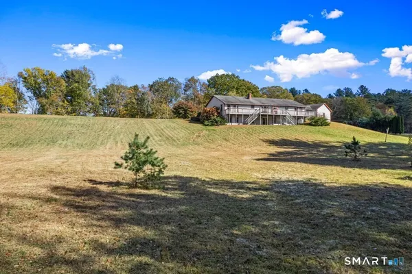 a view of a house with a yard and balcony