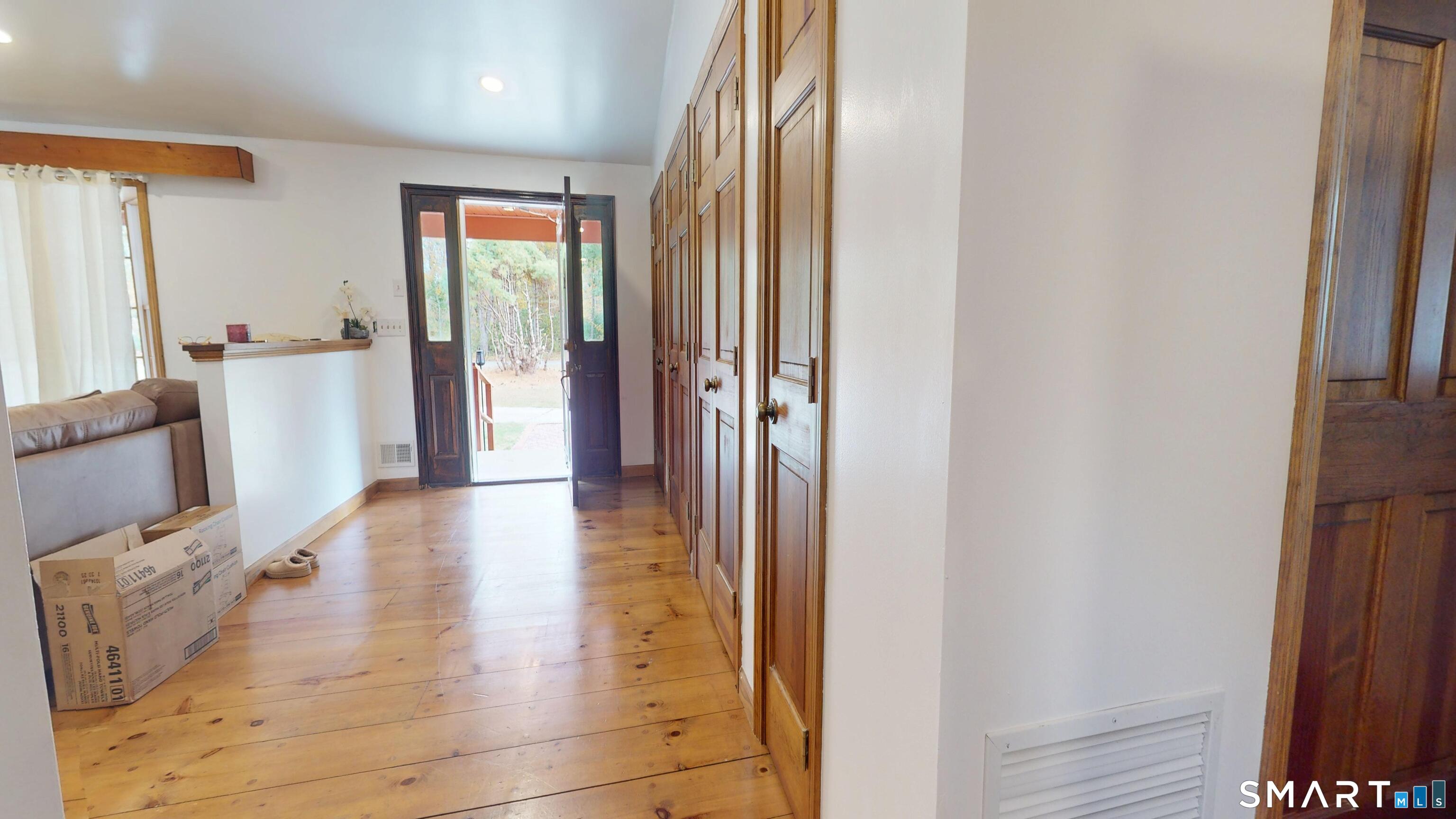 41 Mill Bridge Road Eastford, CT 06242 - Photo 13 of 39 a view of a hallway with wooden floor and furniture