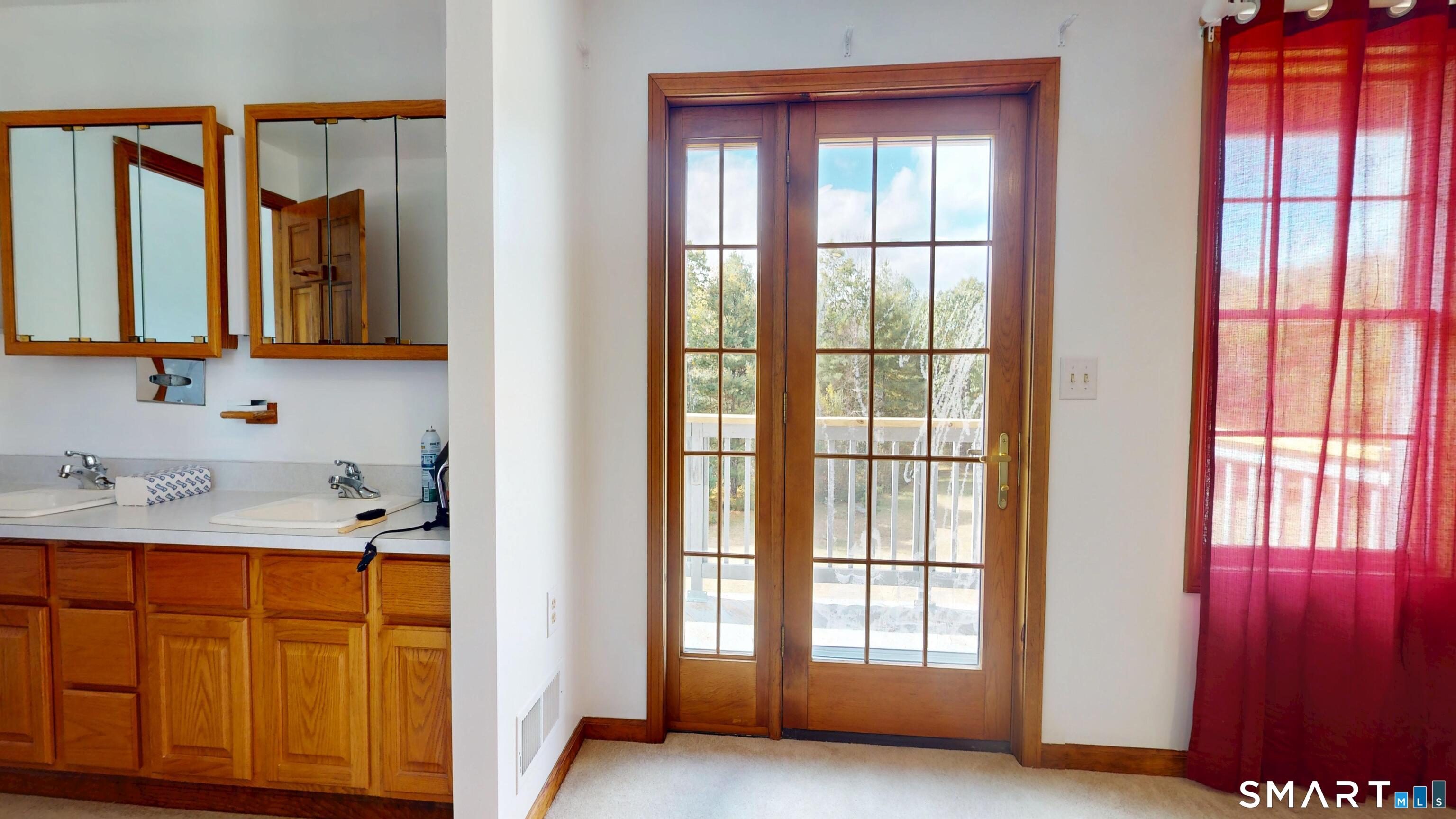 41 Mill Bridge Road Eastford, CT 06242 - Photo 17 of 39 a bathroom with a sink a mirror and next to a window