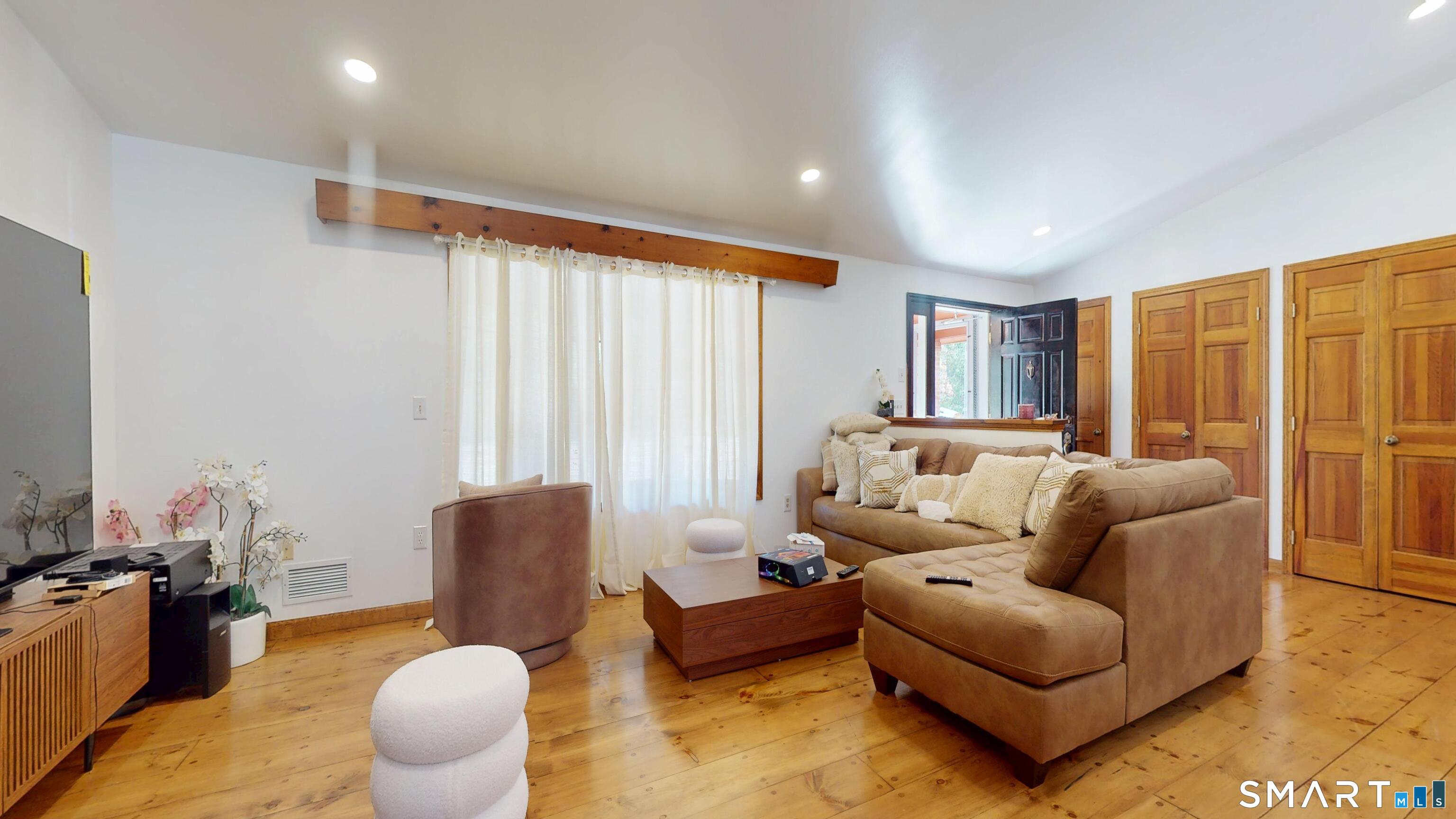 41 Mill Bridge Road Eastford, CT 06242 - Photo 25 of 39 a living room with furniture and a large window