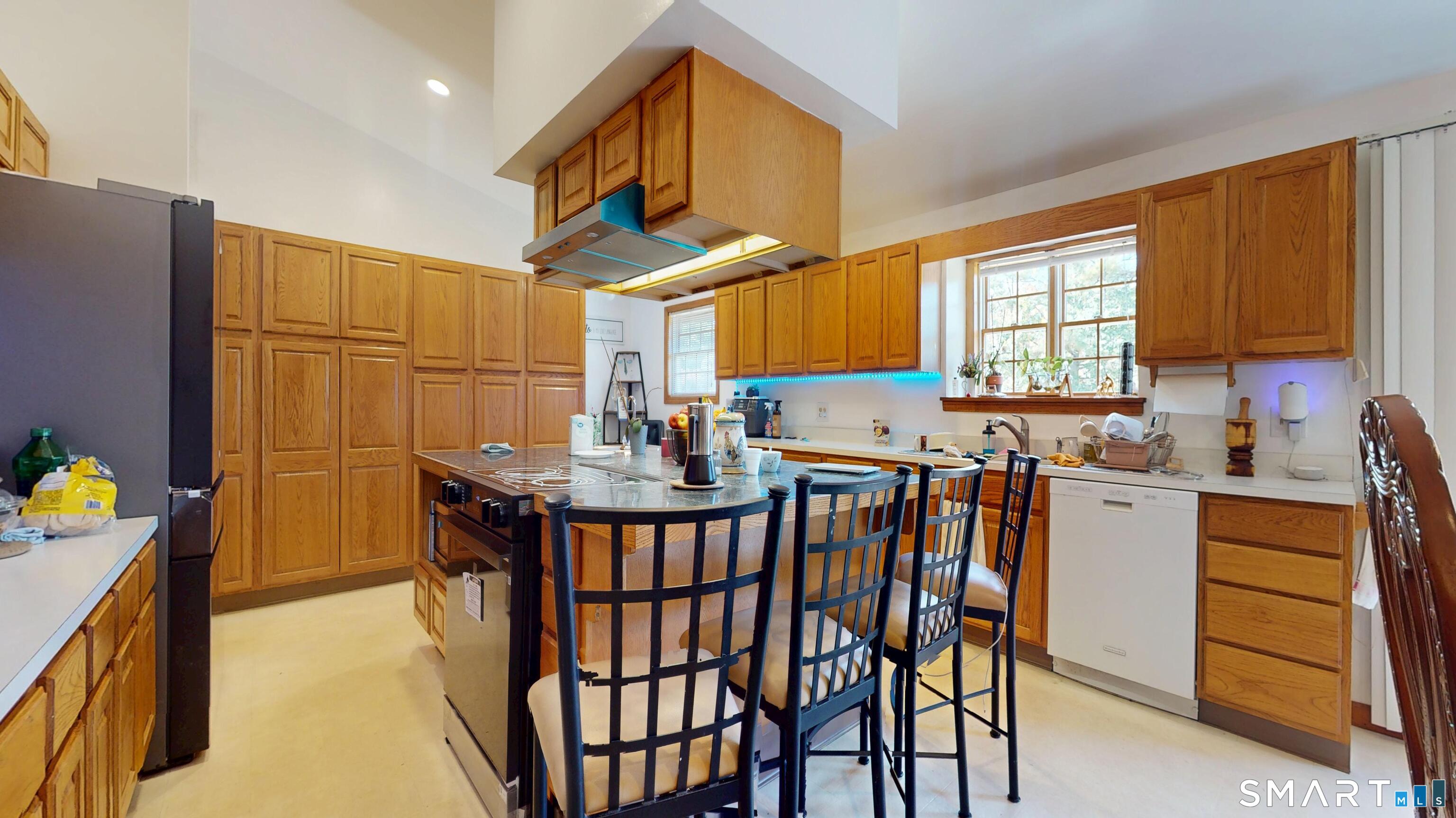 41 Mill Bridge Road Eastford, CT 06242 - Photo 27 of 39 a kitchen with stainless steel appliances kitchen island granite countertop a table chairs in it and a window