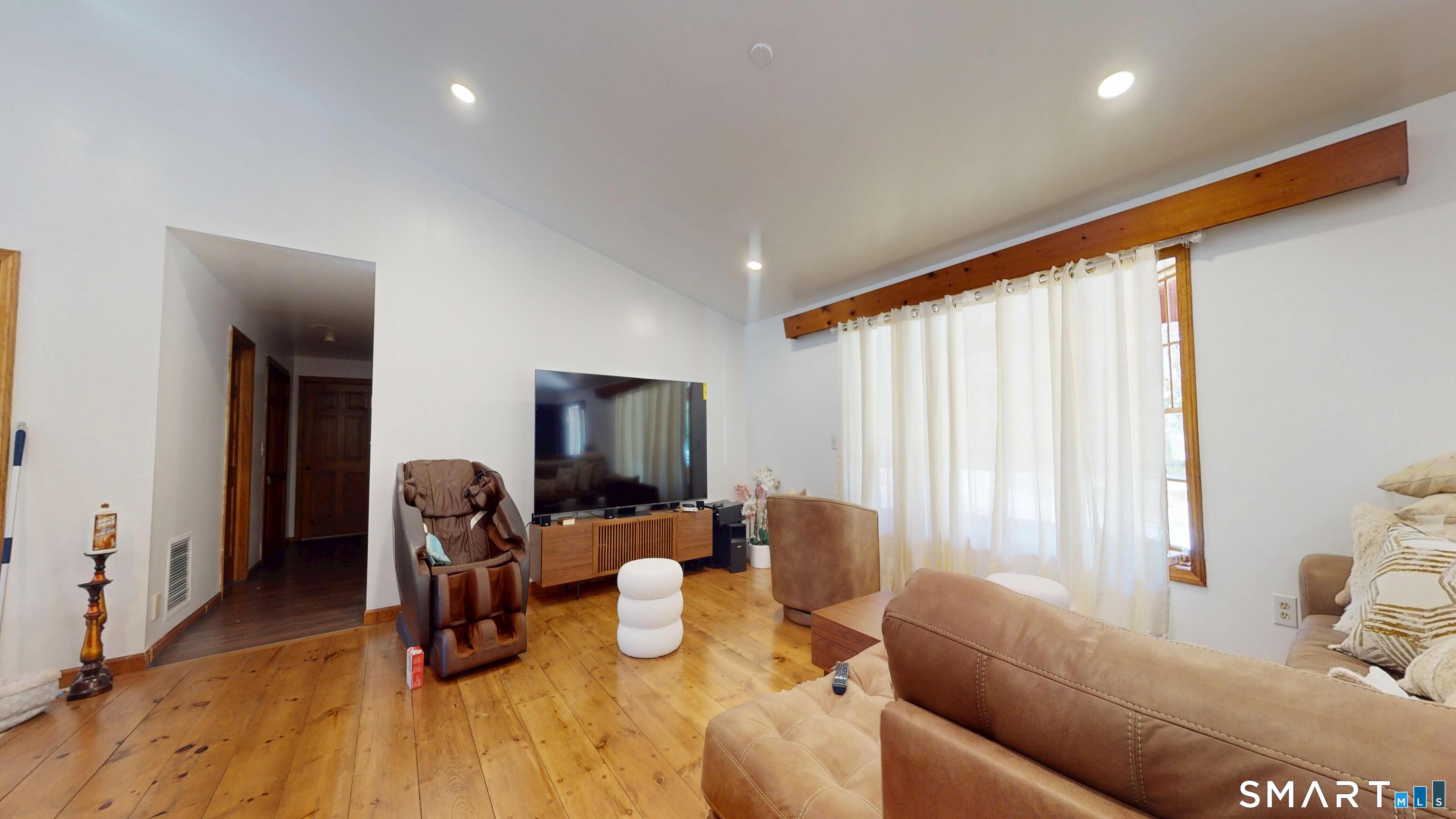 41 Mill Bridge Road Eastford, CT 06242 - Photo 6 of 39 a living room with furniture a flat screen tv and a window