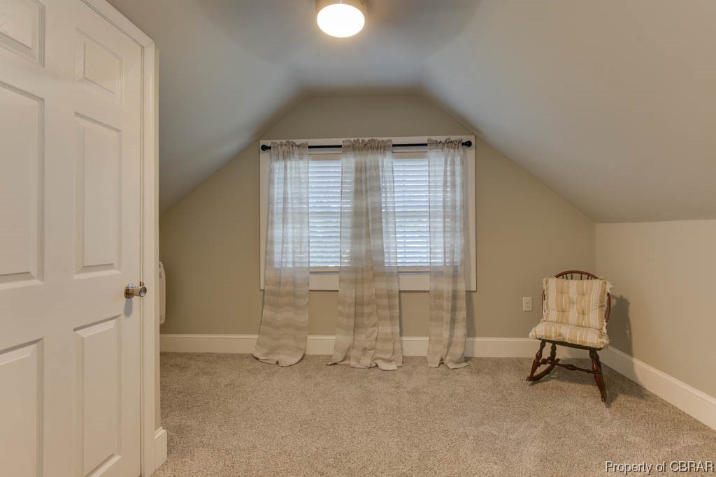 8714 Guinea Road Hayes, VA 23072 - Photo 30 of 44 Sitting room with light colored carpet and vaulted ceiling