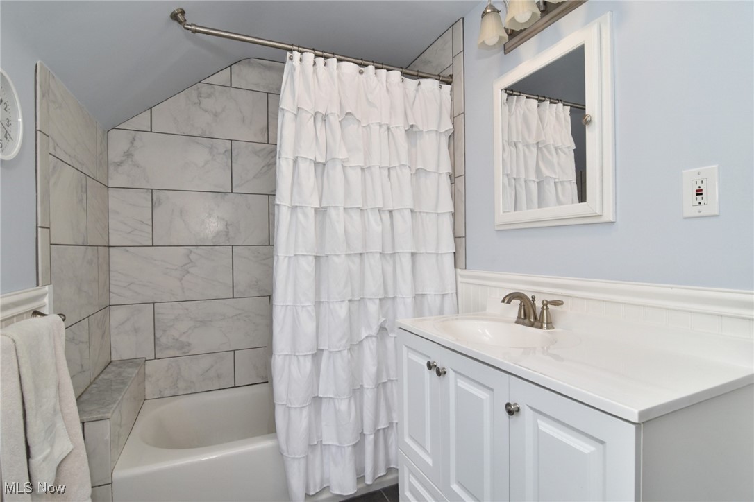 2278 Traymore Road Cleveland, OH 44118 - Photo 33 of 49 Bathroom with vanity, shower / bath combo with shower curtain, and vaulted ceiling