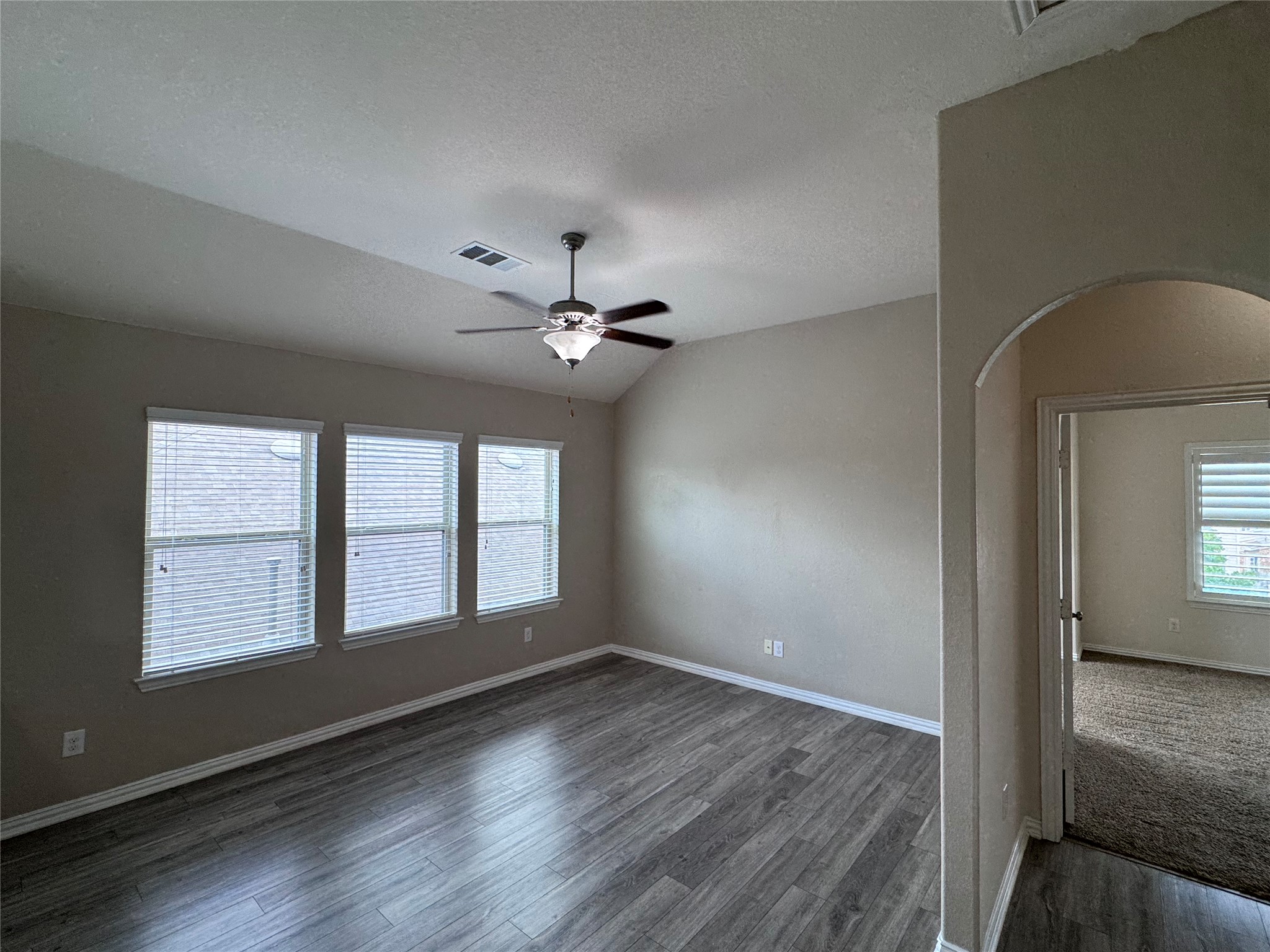 2605 Rough Berry Road Pflugerville, TX 78660 - Photo 19 of 40 Three generous windows illuminate this well-proportioned bedroom, offering a comfortable living space.