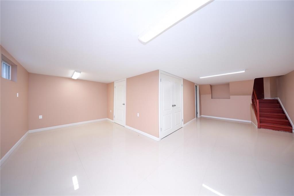 8756 26th Avenue Brooklyn, NY 11214 - Photo 17 of 26 a view of an empty room with wooden floor