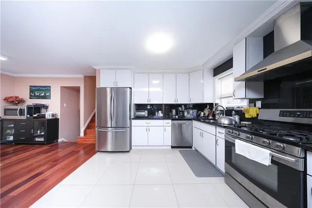 a kitchen with a refrigerator and a stove top oven