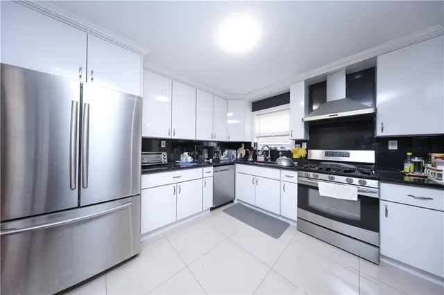 a kitchen with stainless steel appliances granite countertop a refrigerator sink and stove