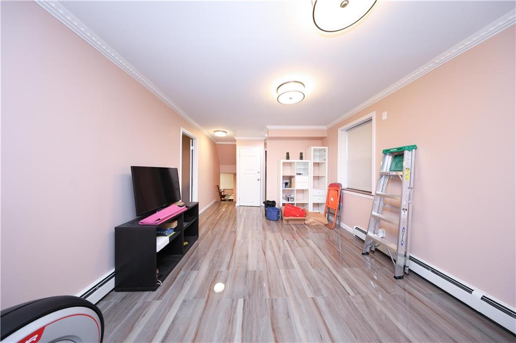 8756 26th Avenue Brooklyn, NY 11214 - Photo 9 of 26 a living room with furniture and a flat screen tv