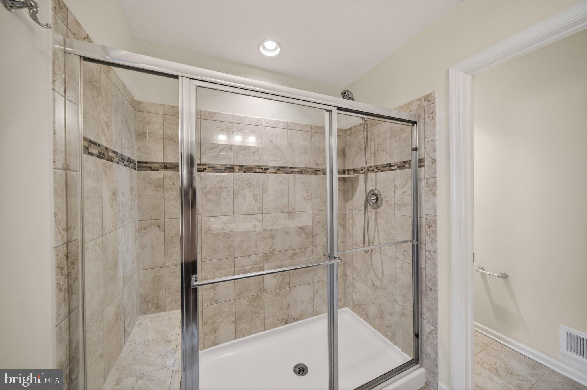 8475 Randell Ridge Road Frederick, MD 21704 - Photo 22 of 36 Sleek modern shower with elegant tiles.