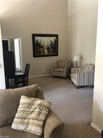 a living room with furniture rug and a lamp