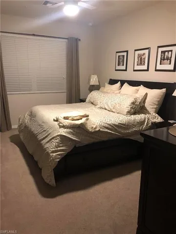 a bedroom with a bed and wall painting