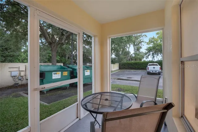 a view of a porch with furniture and a yard