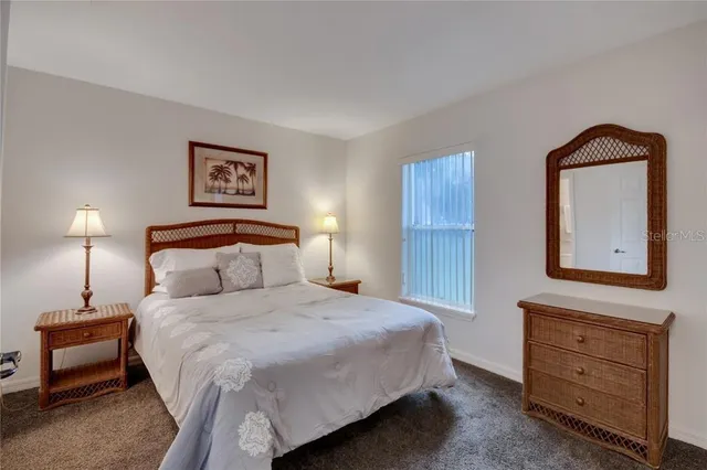 a bedroom with a bed and a night stand