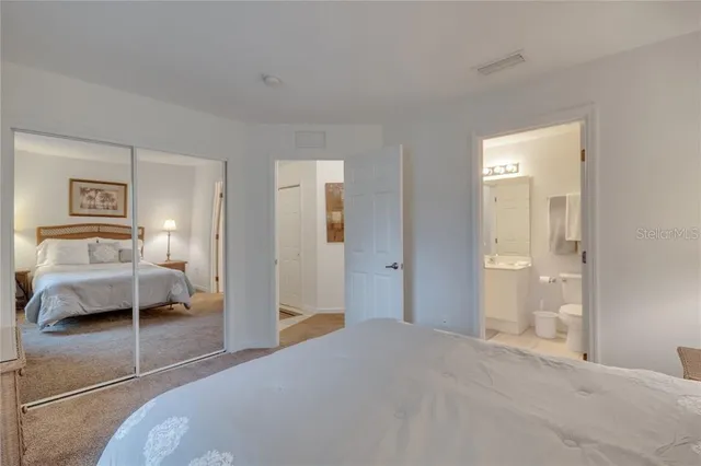 a bedroom with a bed and a mirror