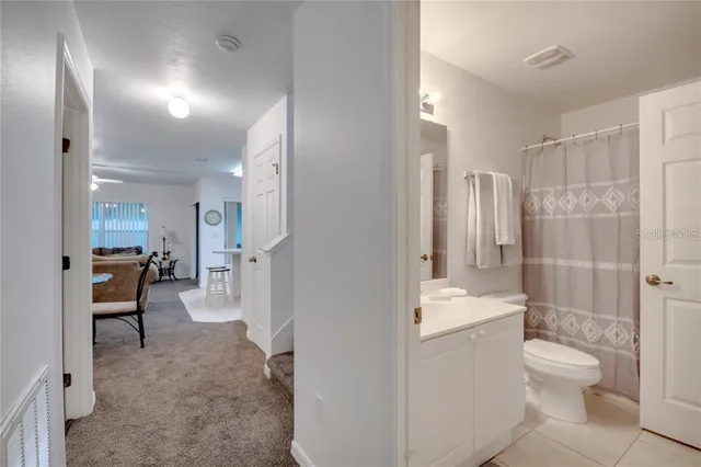 a bathroom with a toilet sink shower and mirror