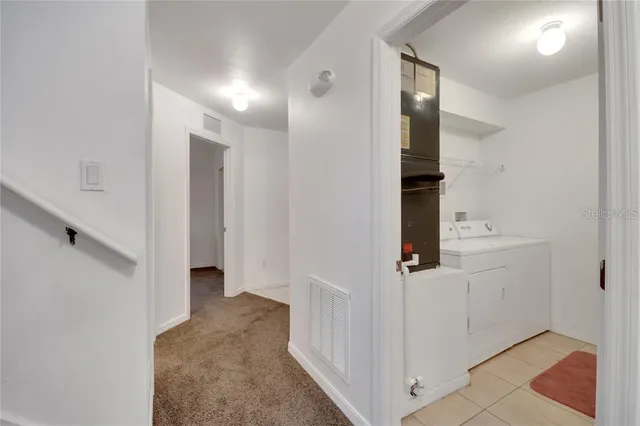 a view of a hallway with paintings on the wall