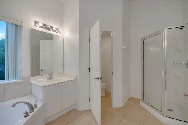a bathroom with a sink and mirror with toilet