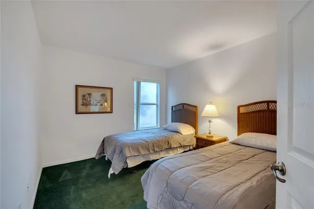 a bedroom with two beds and painting on the wall