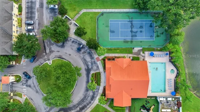 an aerial view of a house with a garden and trees