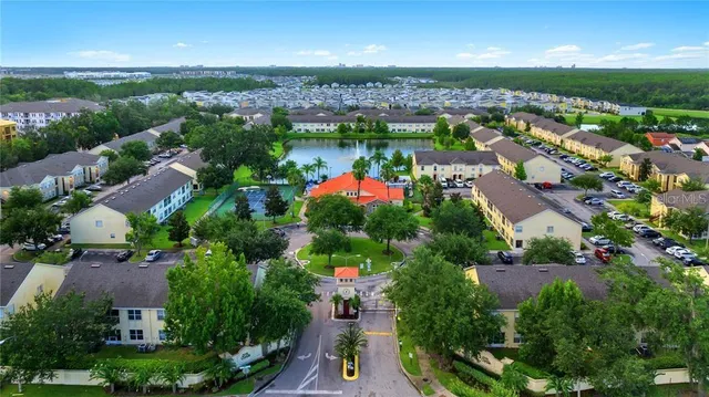 an aerial view of residential houses with outdoor space and pool