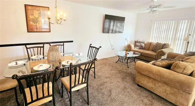 a living room with furniture wooden floor and a window