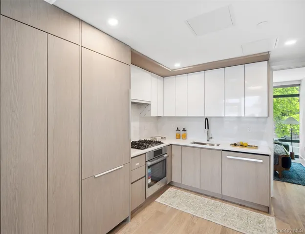 a kitchen with white cabinets and white appliances