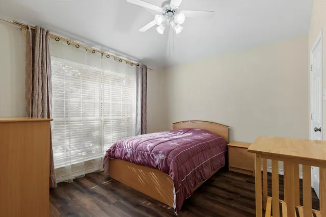 a bedroom with a bed and window