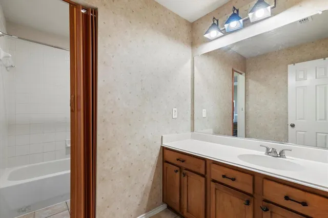 a bathroom with a double vanity sink a mirror and a shower