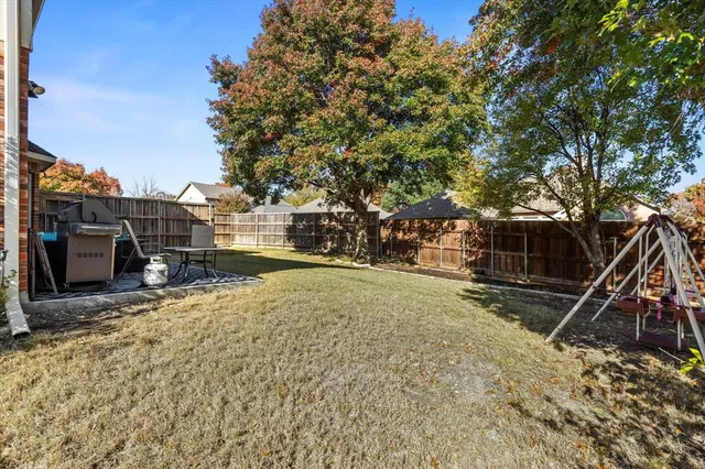 a view of a backyard with a tree