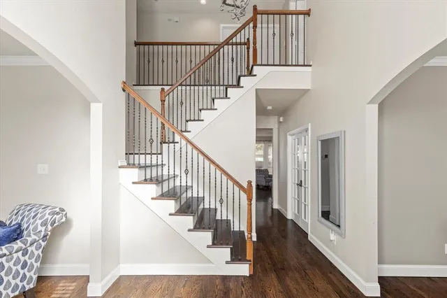 a view of entryway and hall with wooden floor