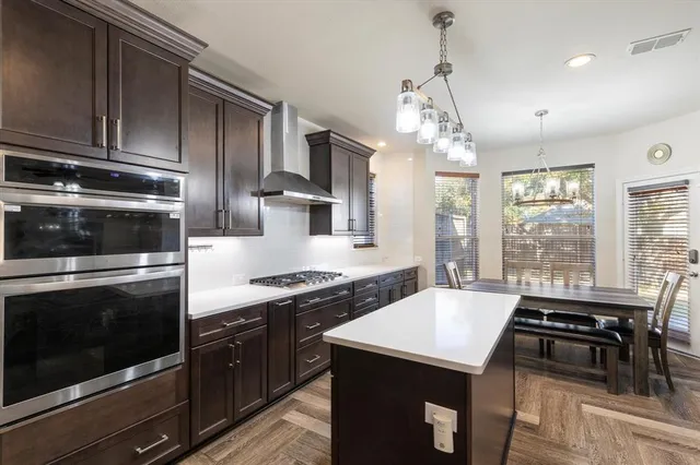 a kitchen with a stove sink and microwave