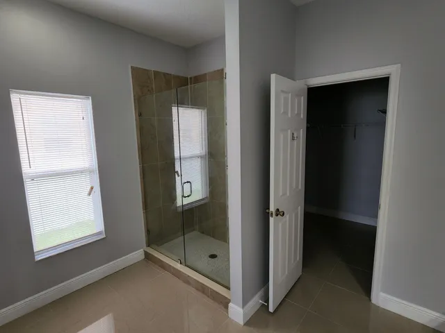 a bathroom with a glass shower door