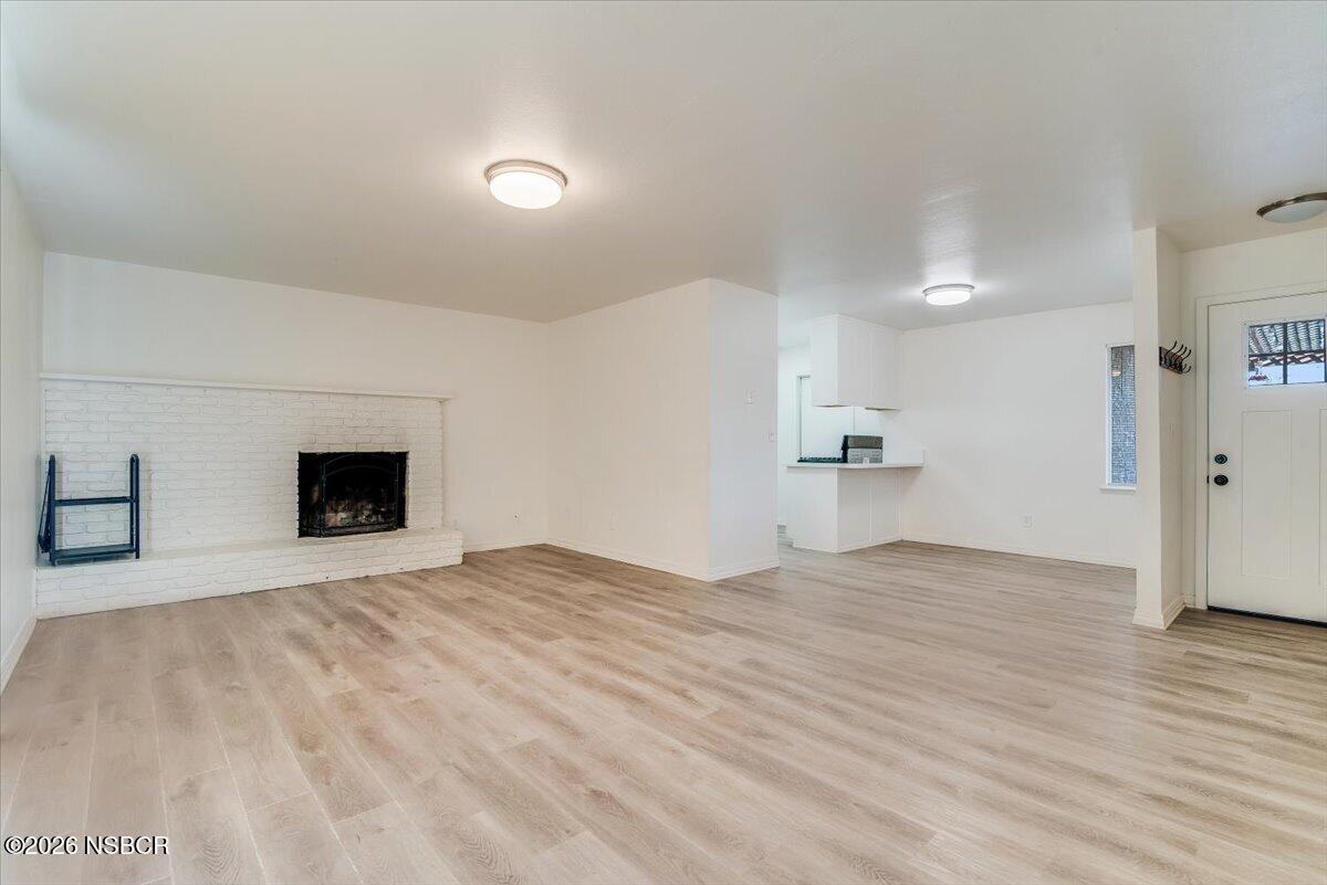 321 North Z Street Lompoc, CA 93436 - Photo 6 of 33 a view of empty room with wooden floor and fireplace