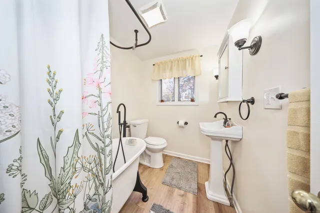 a bathroom with a toilet sink and mirror