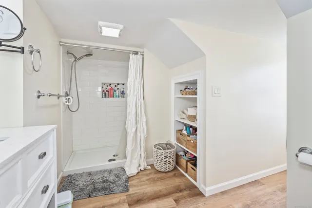 a bathroom with a sink toilet and shower