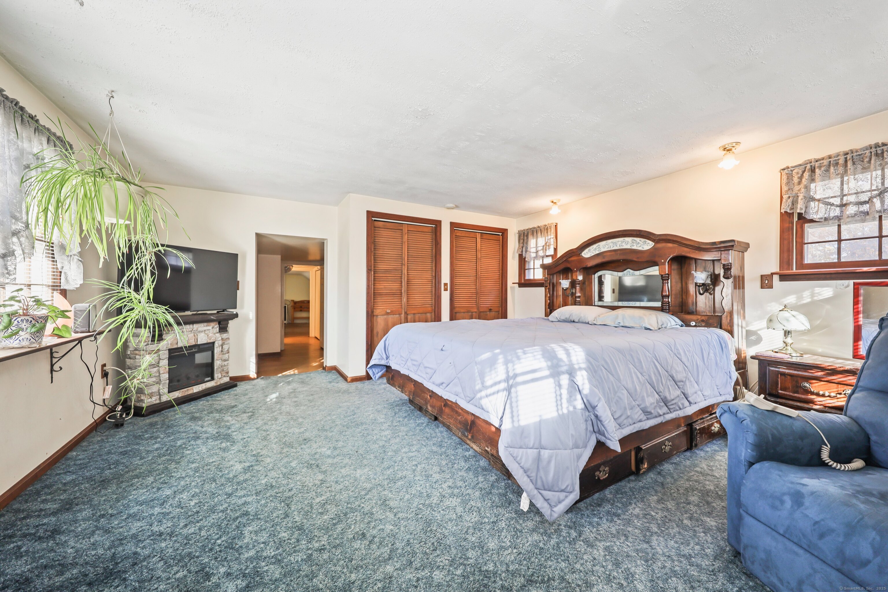 20 Hydelor Avenue Prospect, CT 06712 - Photo 27 of 40 a spacious bedroom with a bed and a flat tv screen