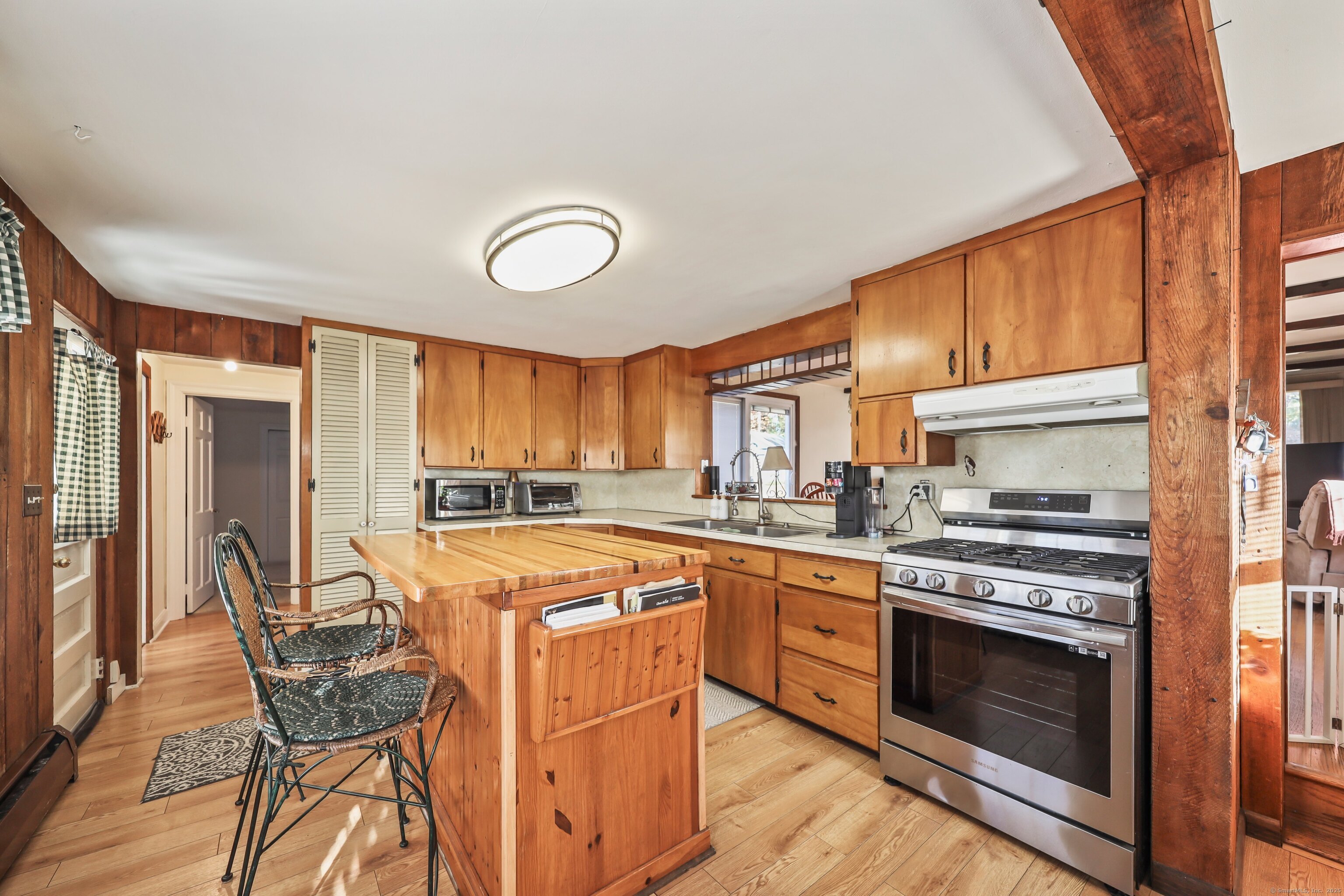 20 Hydelor Avenue Prospect, CT 06712 - Photo 6 of 40 a kitchen with stainless steel appliances granite countertop a stove top oven a sink dishwasher and white cabinets with wooden floor