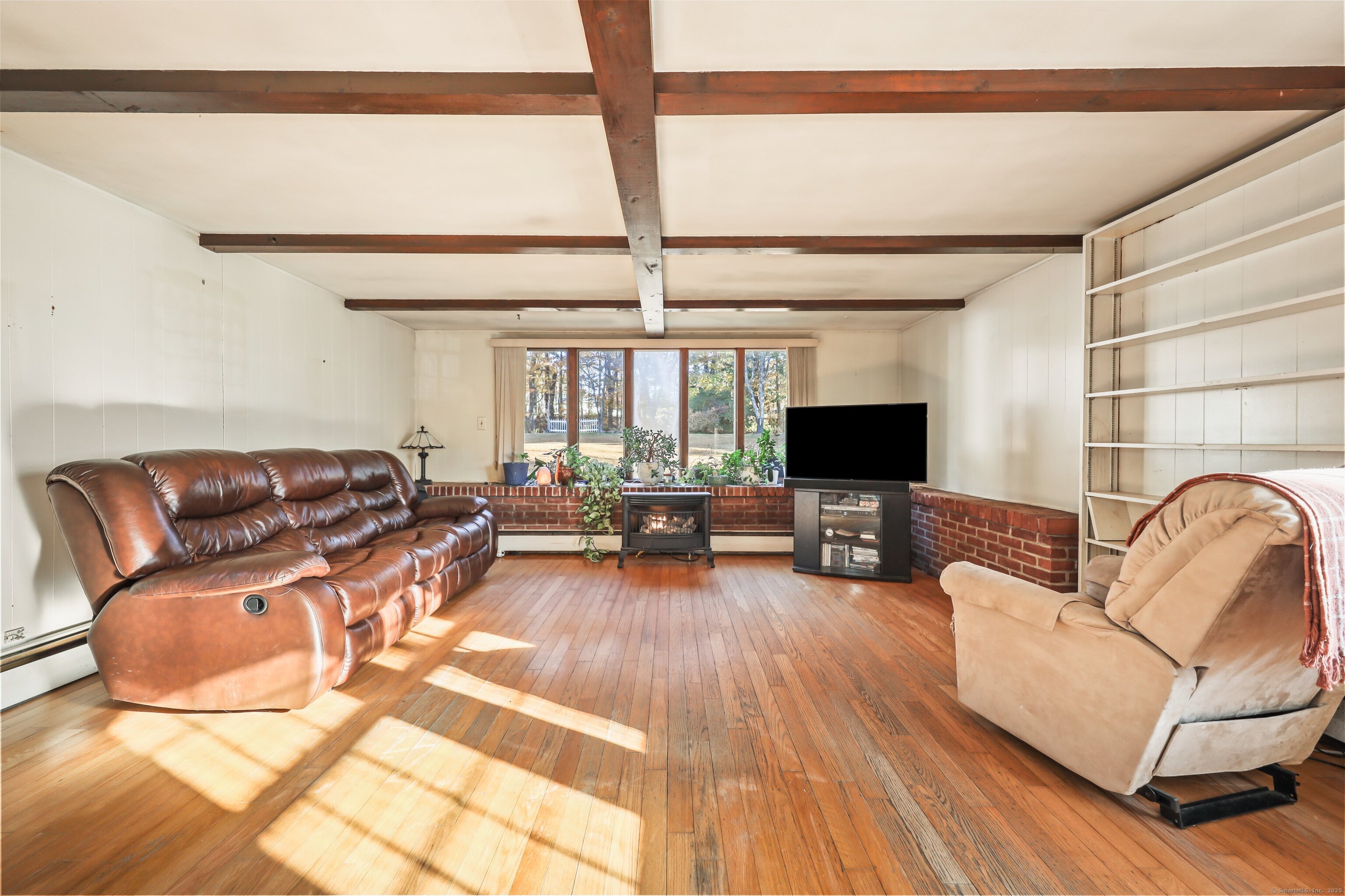 20 Hydelor Avenue Prospect, CT 06712 - Photo 10 of 40 a living room with furniture flat screen tv and a fireplace