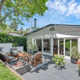 a backyard of a house with yard barbeque oven and outdoor seating