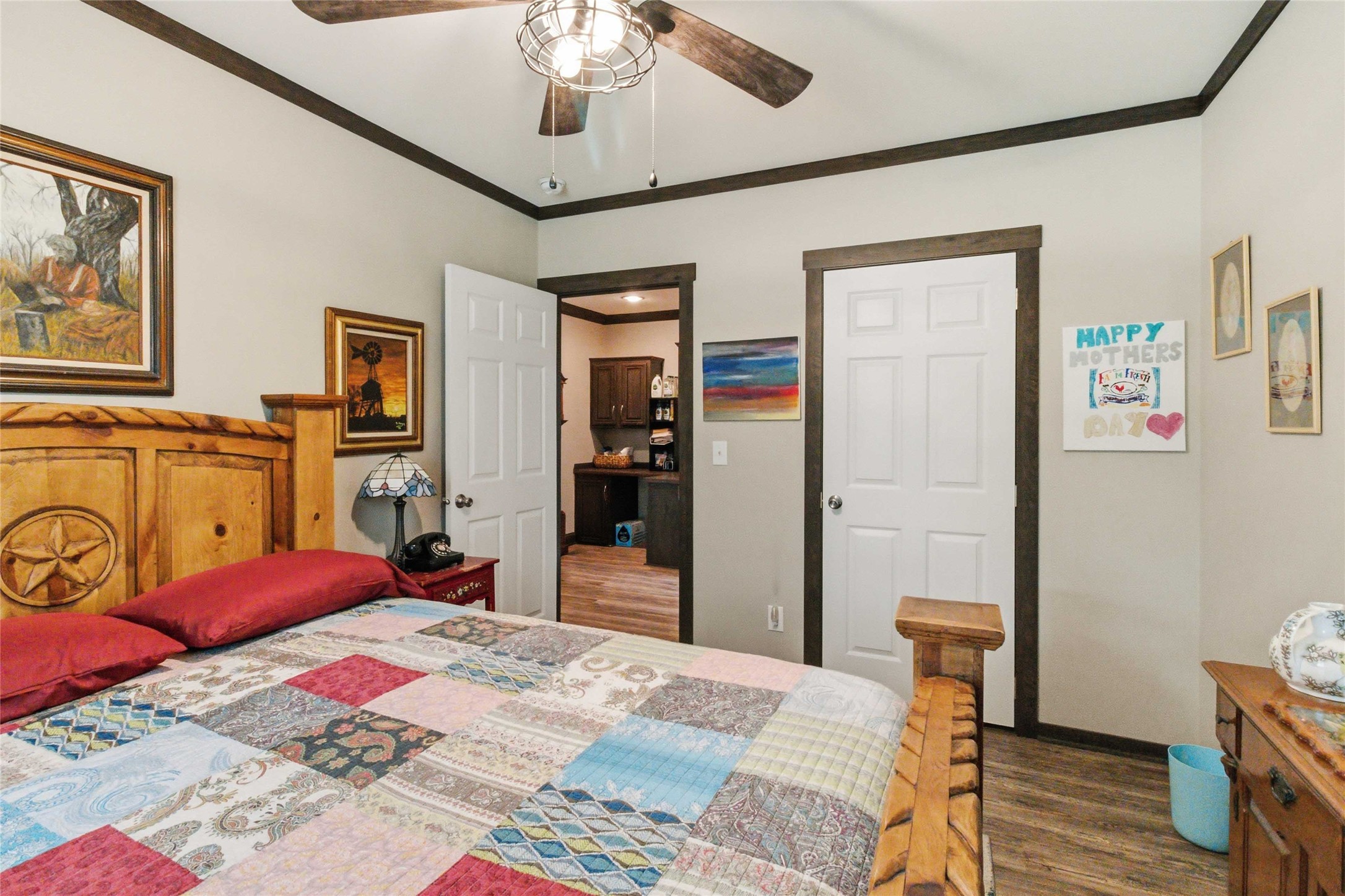 7921 Vista Ranch Road Smithville, TX 78957 - Photo 19 of 39 Relax in this well-lit bedroom featuring a ceiling fan and rich wood trim details.