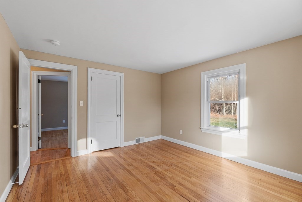 22 Parker Road Shirley, MA 01464 - Photo 11 of 41 a view of an empty room with wooden floor and a window